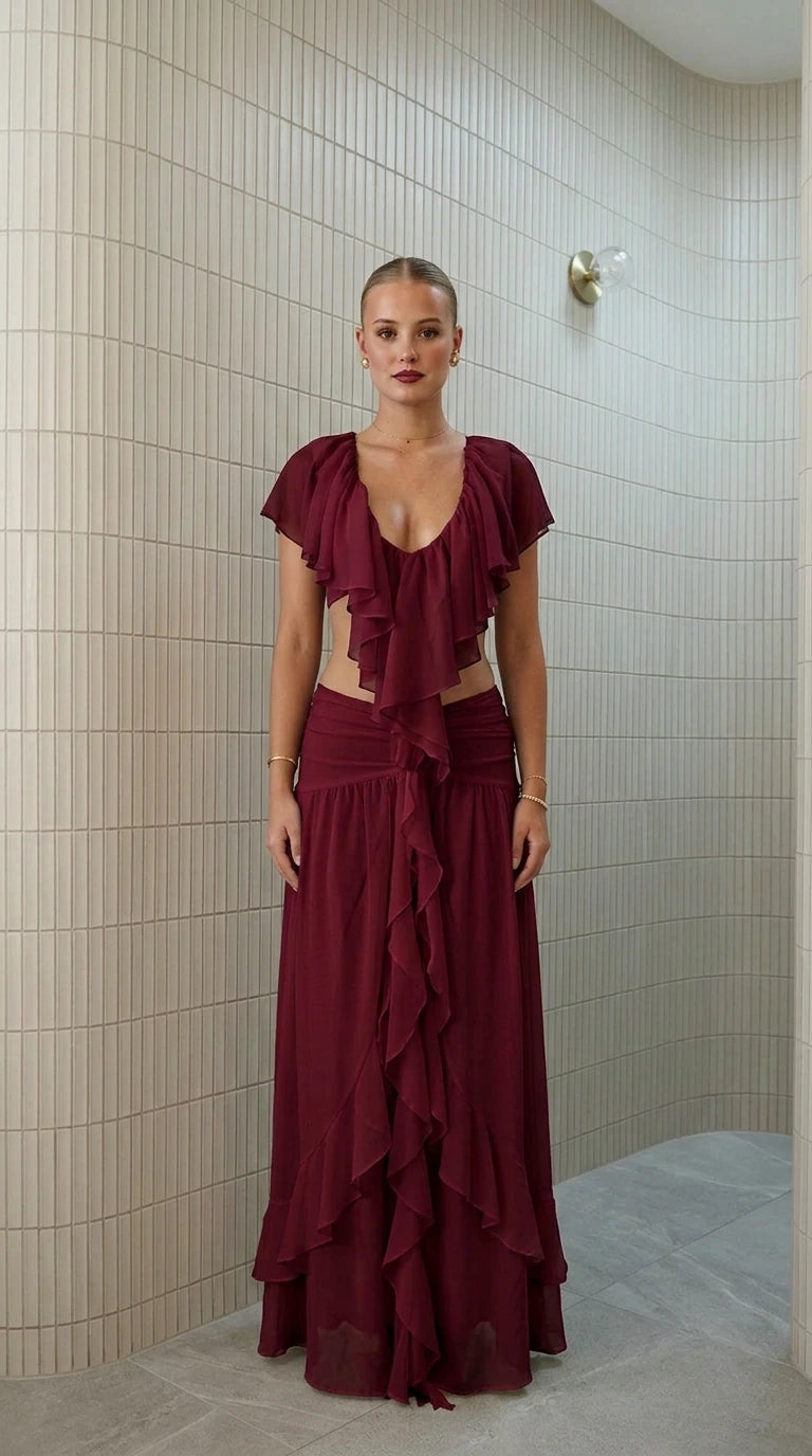 Front view of model wearing burgundy ruffled two-piece maxi set