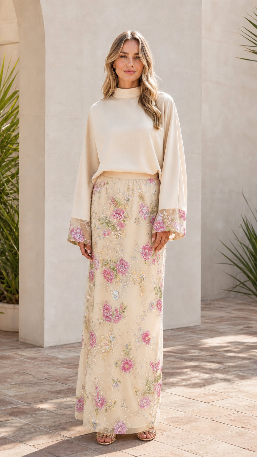 Model wearing champagne two-piece floral embroidered maxi set