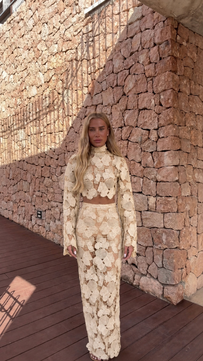 Model wearing cream crochet lace two-piece set