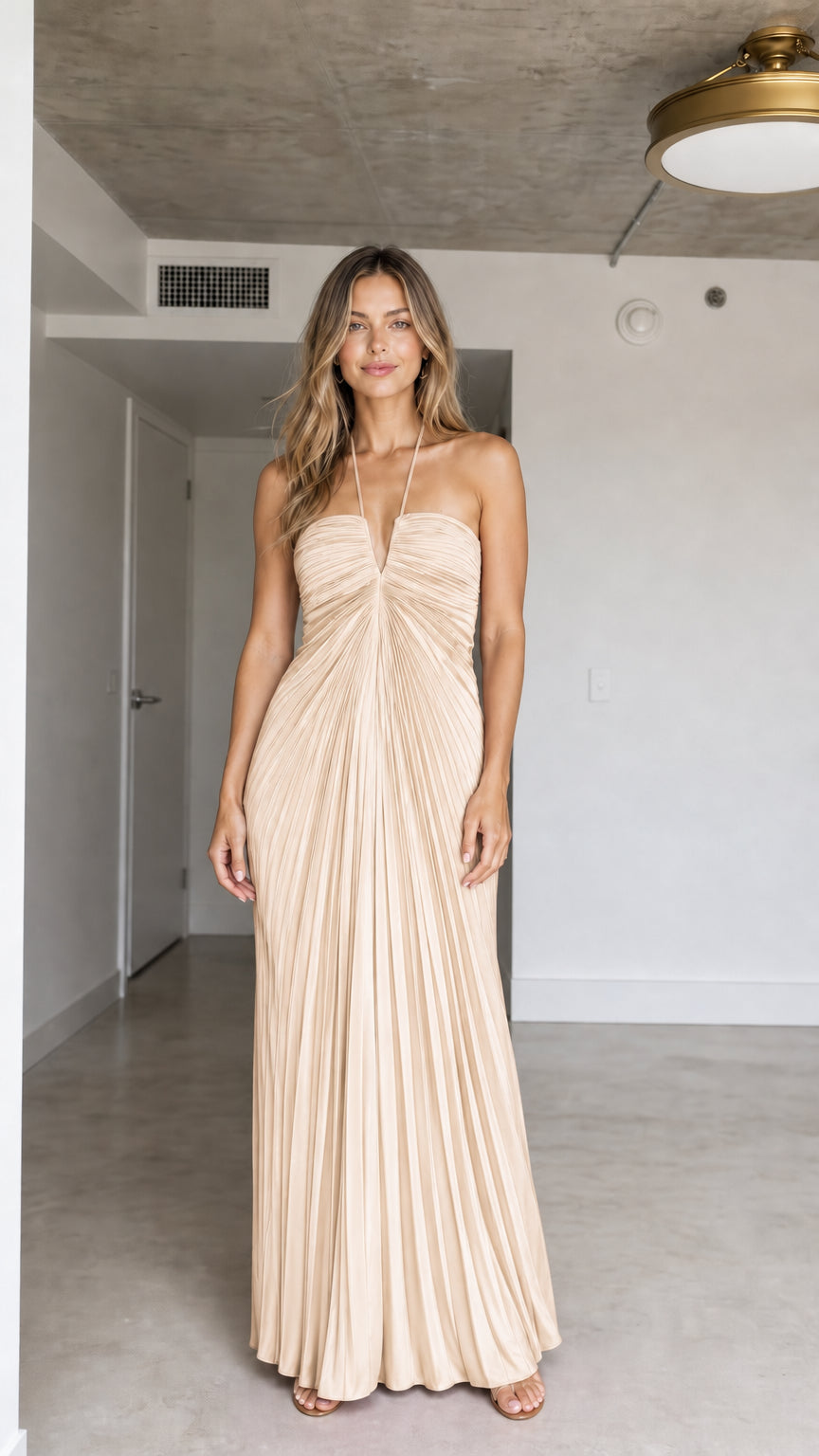 Front view of model wearing Champagne halter pleated maxi dress