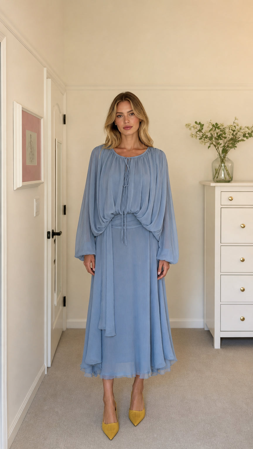 Front view of model wearing light blue long-sleeve pleated midi dress