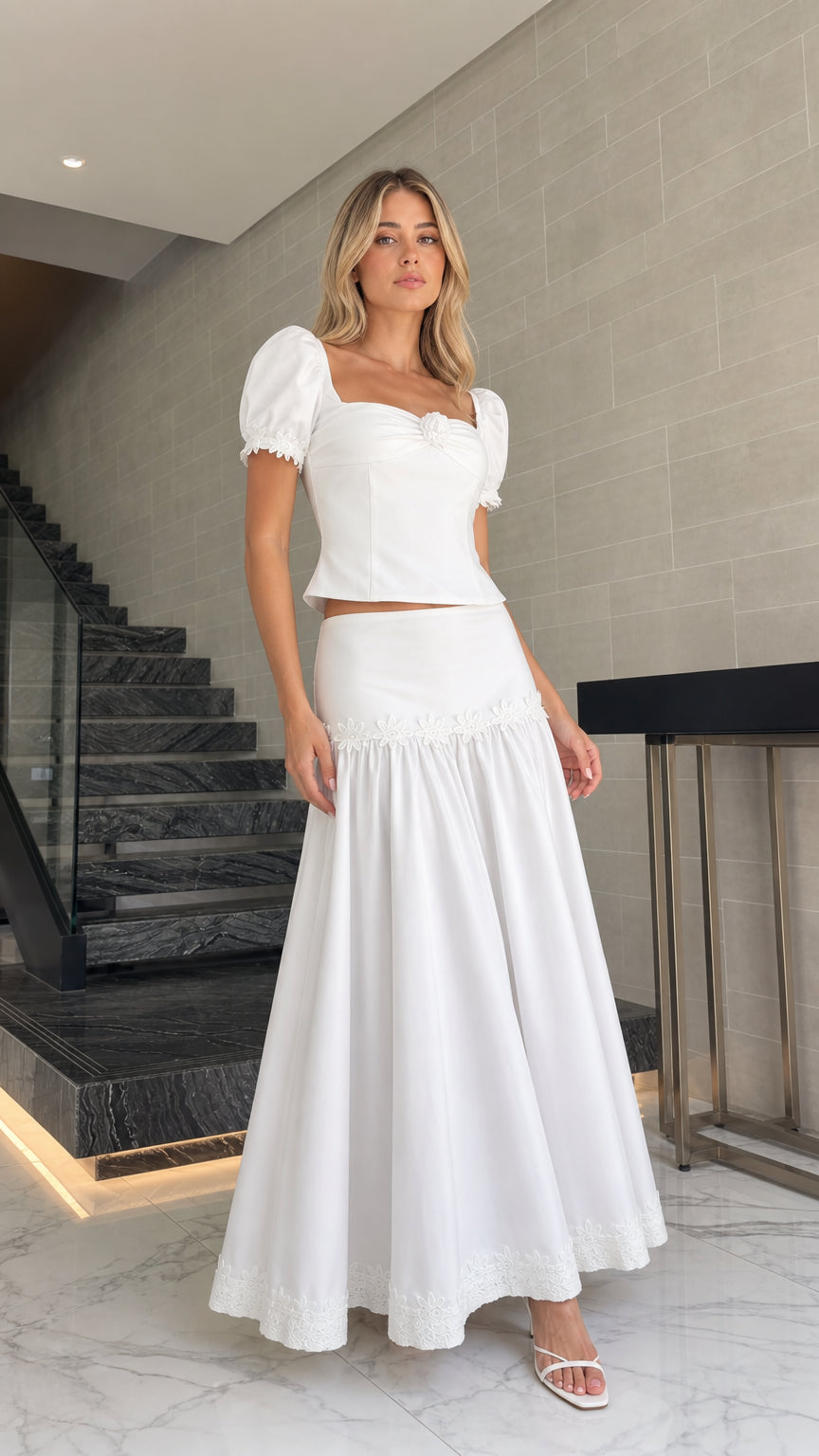 Model wearing white puff sleeve crop top and tiered maxi skirt set, front view