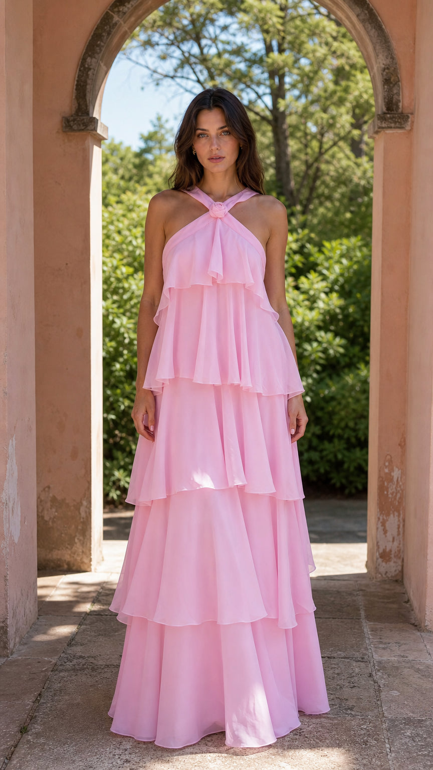 Front view of model wearing pink halter neck tiered maxi dress