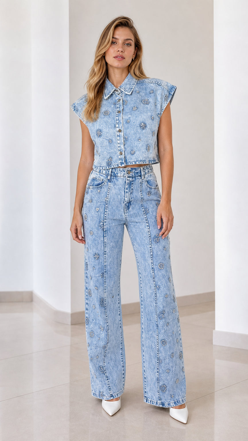 Front view of model wearing light blue embellished denim vest and matching wide-leg pants