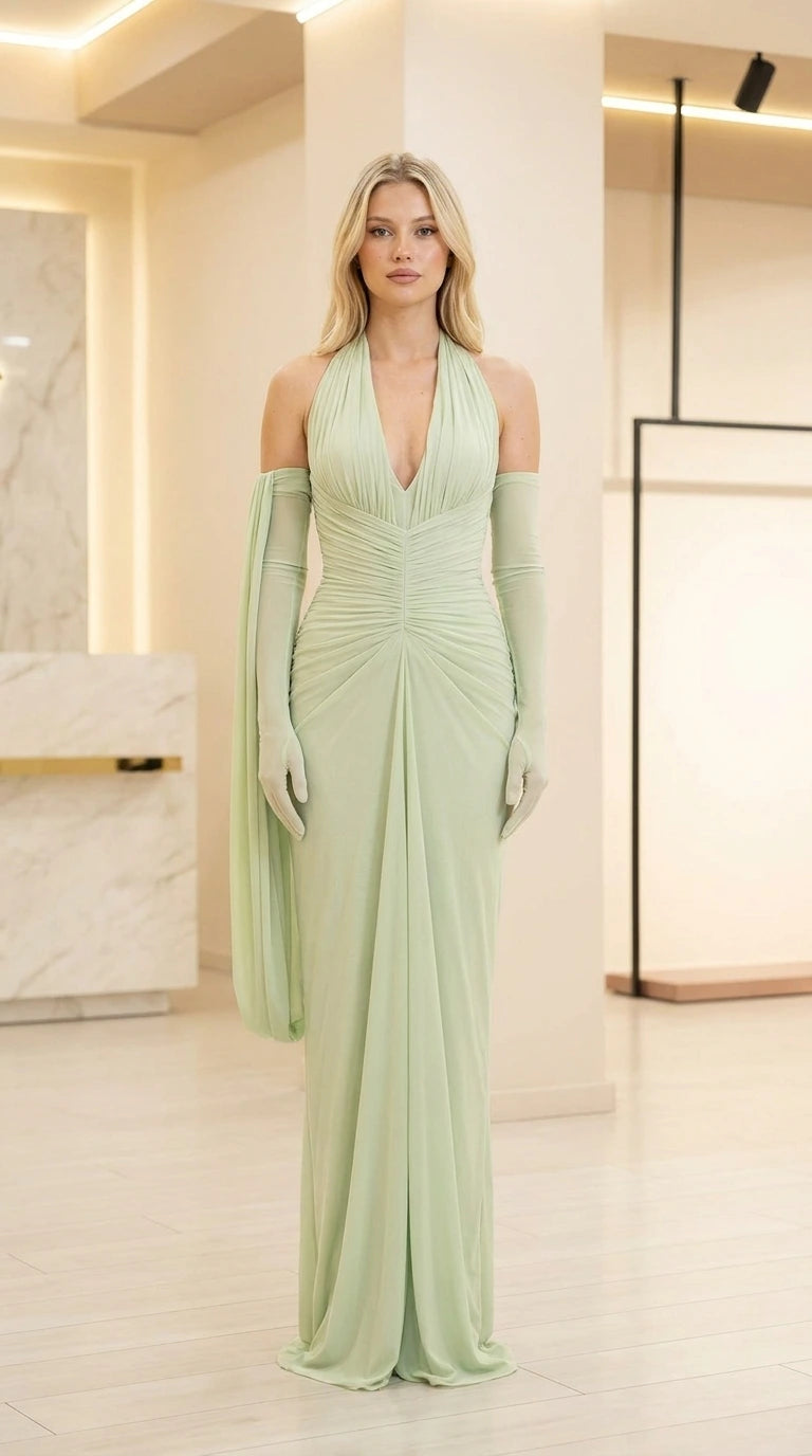 Front view of model wearing sage green ruched halter evening dress with matching sleeves