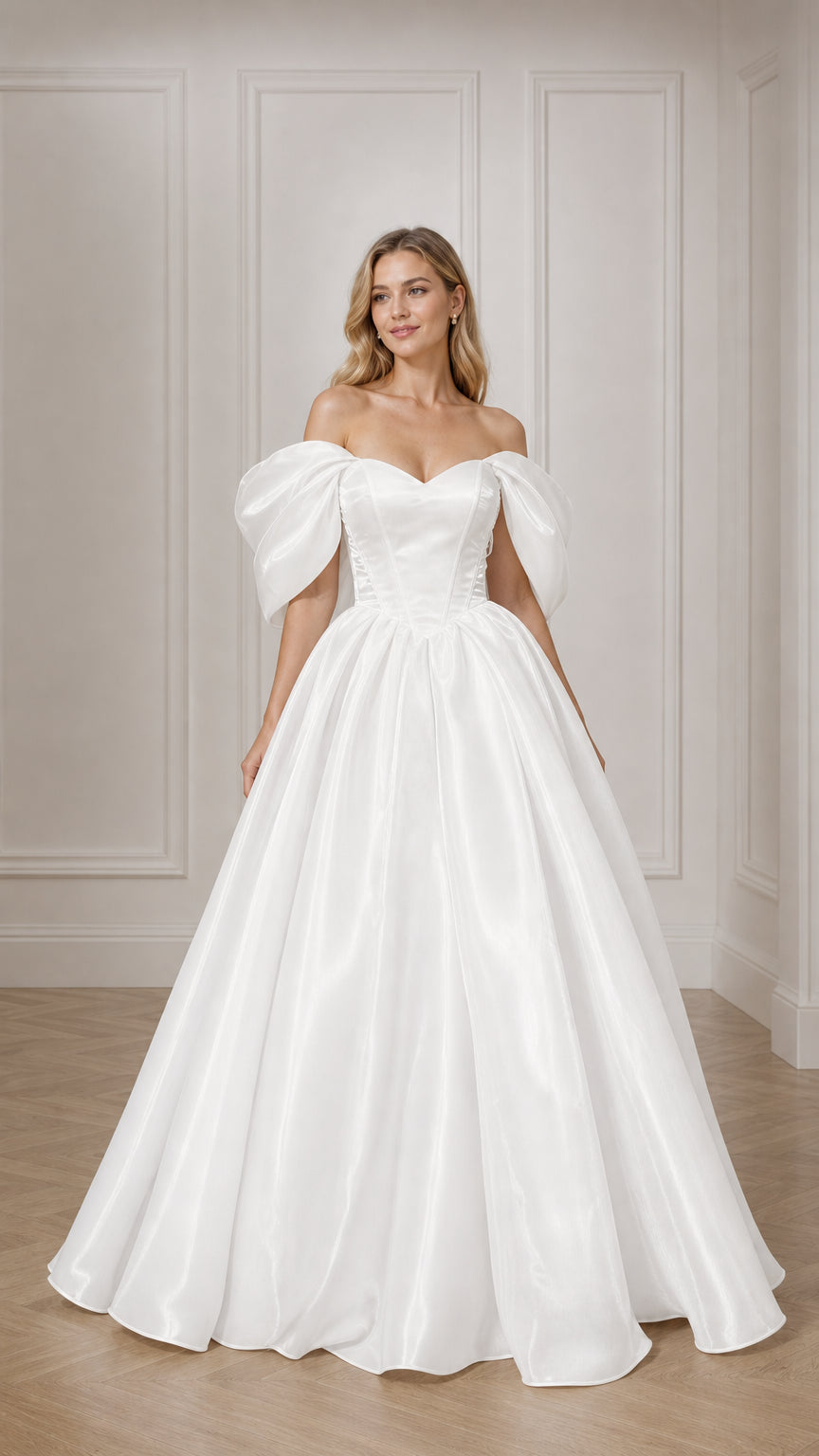 Front view of woman wearing white off-the-shoulder puff sleeve satin ball gown