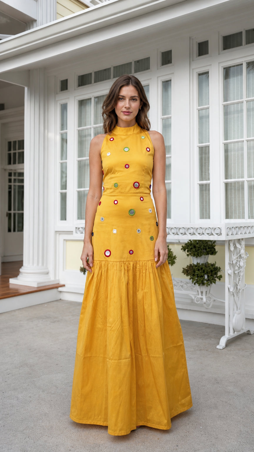 Front view of woman wearing yellow high-neck embellished maxi dress