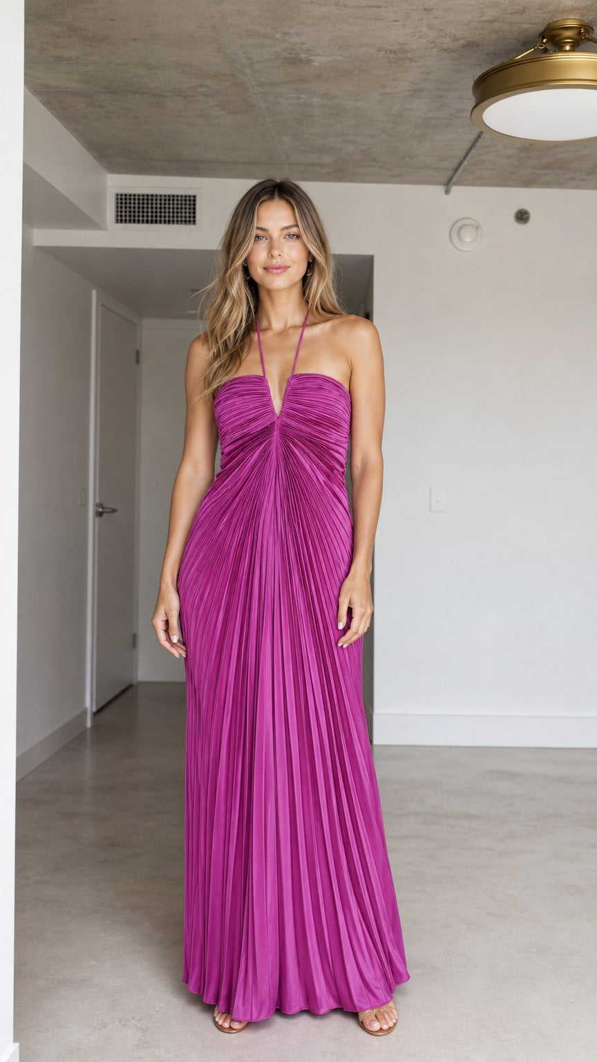 Front view of model wearing Fuchsia halter pleated maxi dress