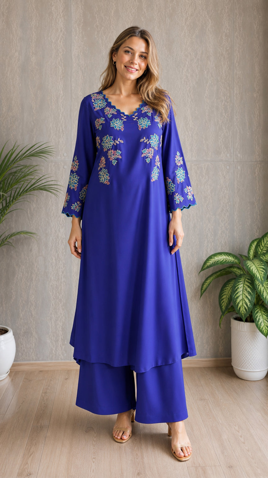 Model wearing royal blue embroidered tunic and wide-leg pants set, front view