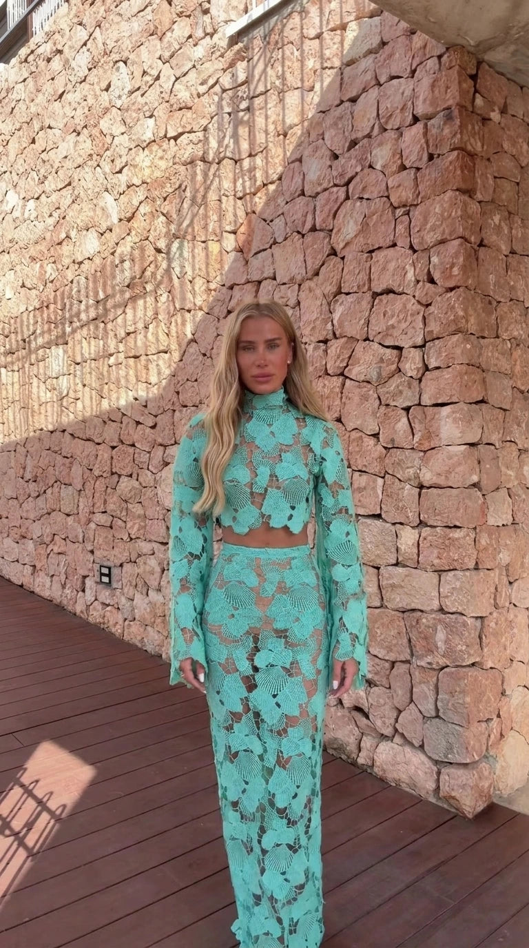 Model wearing turquoise crochet lace two-piece crop top and maxi skirt set from front