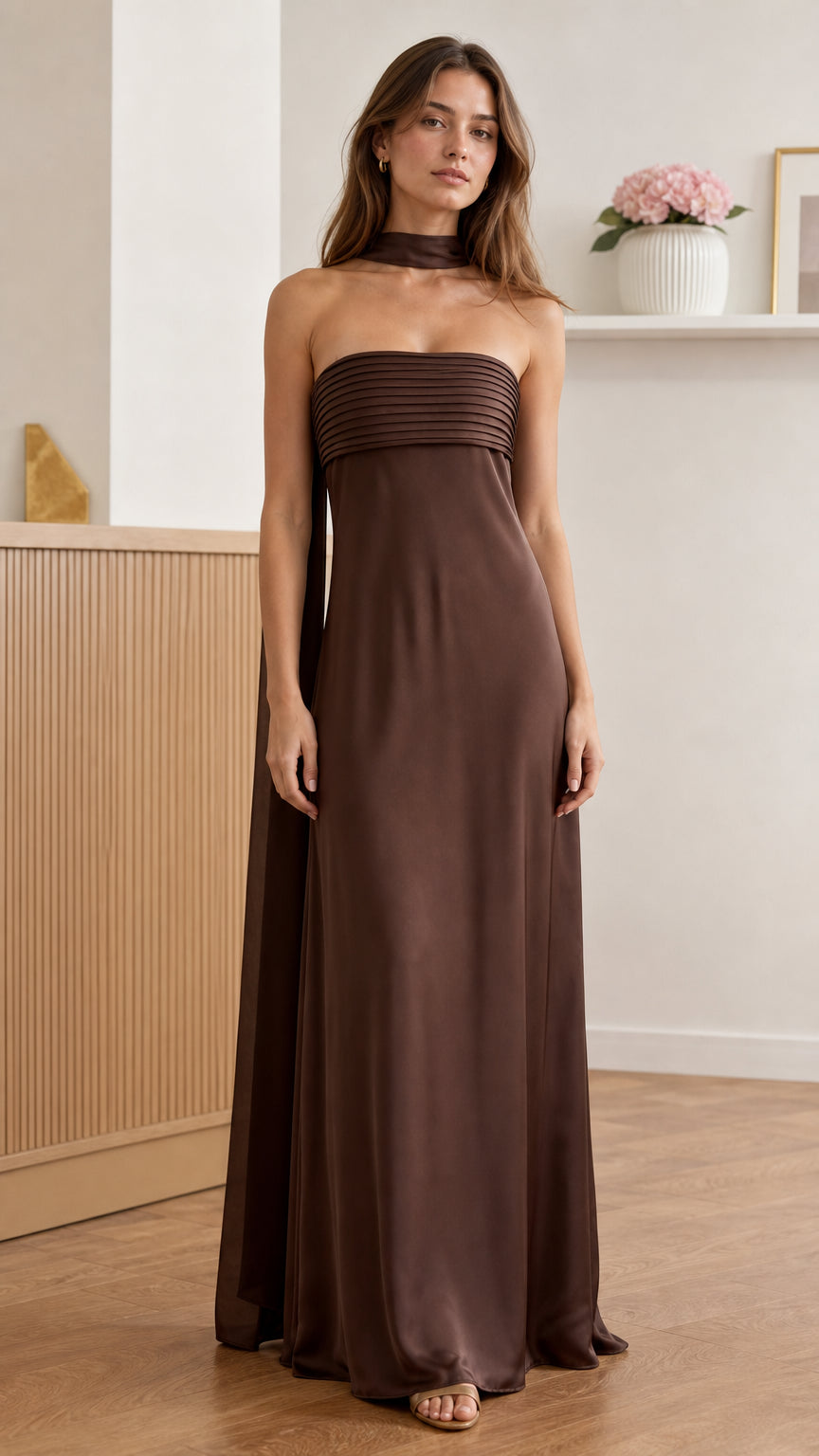 Front view of model wearing brown pleated strapless maxi dress