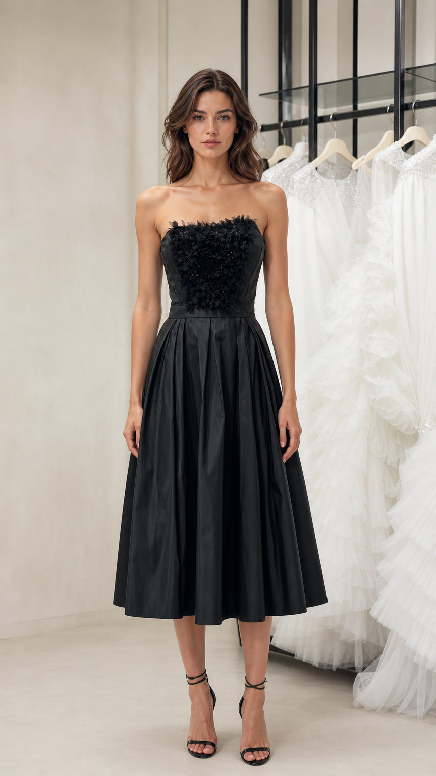 Front view of model wearing black strapless midi dress