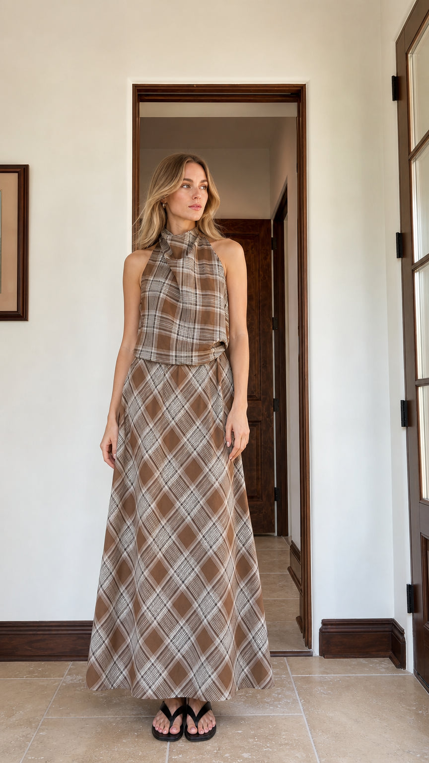 Front view of woman wearing brown plaid halter top and maxi skirt set