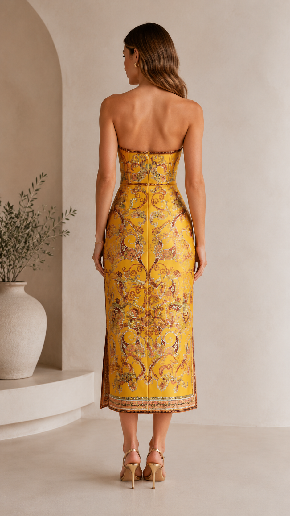 Back view of marigold strapless paisley midi dress