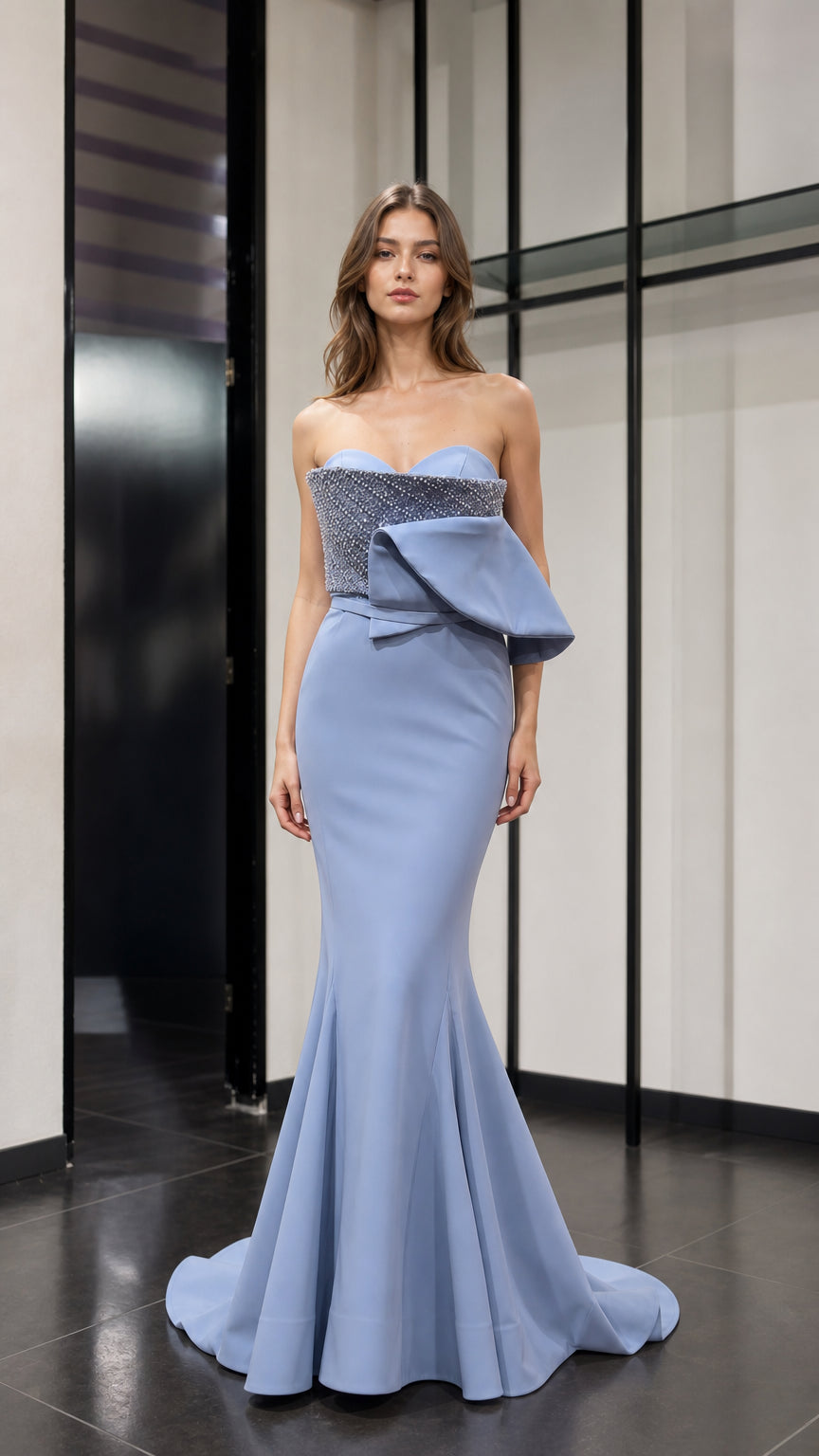 Front view of light blue strapless beaded peplum mermaid evening dress