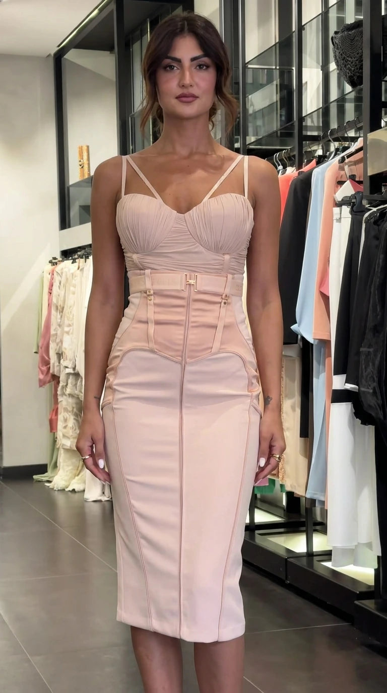 Model wearing blush pink sleeveless ruched bustier midi dress, front view