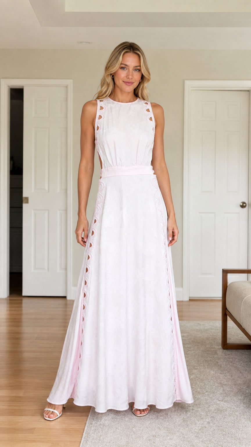 Front view of woman wearing white cutout maxi dress