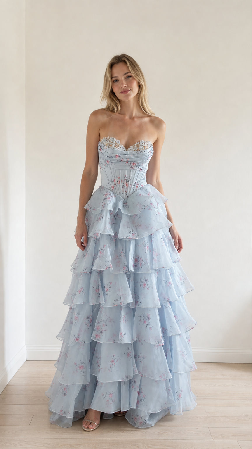 Front view of model wearing light blue floral ruffle strapless corset evening gown