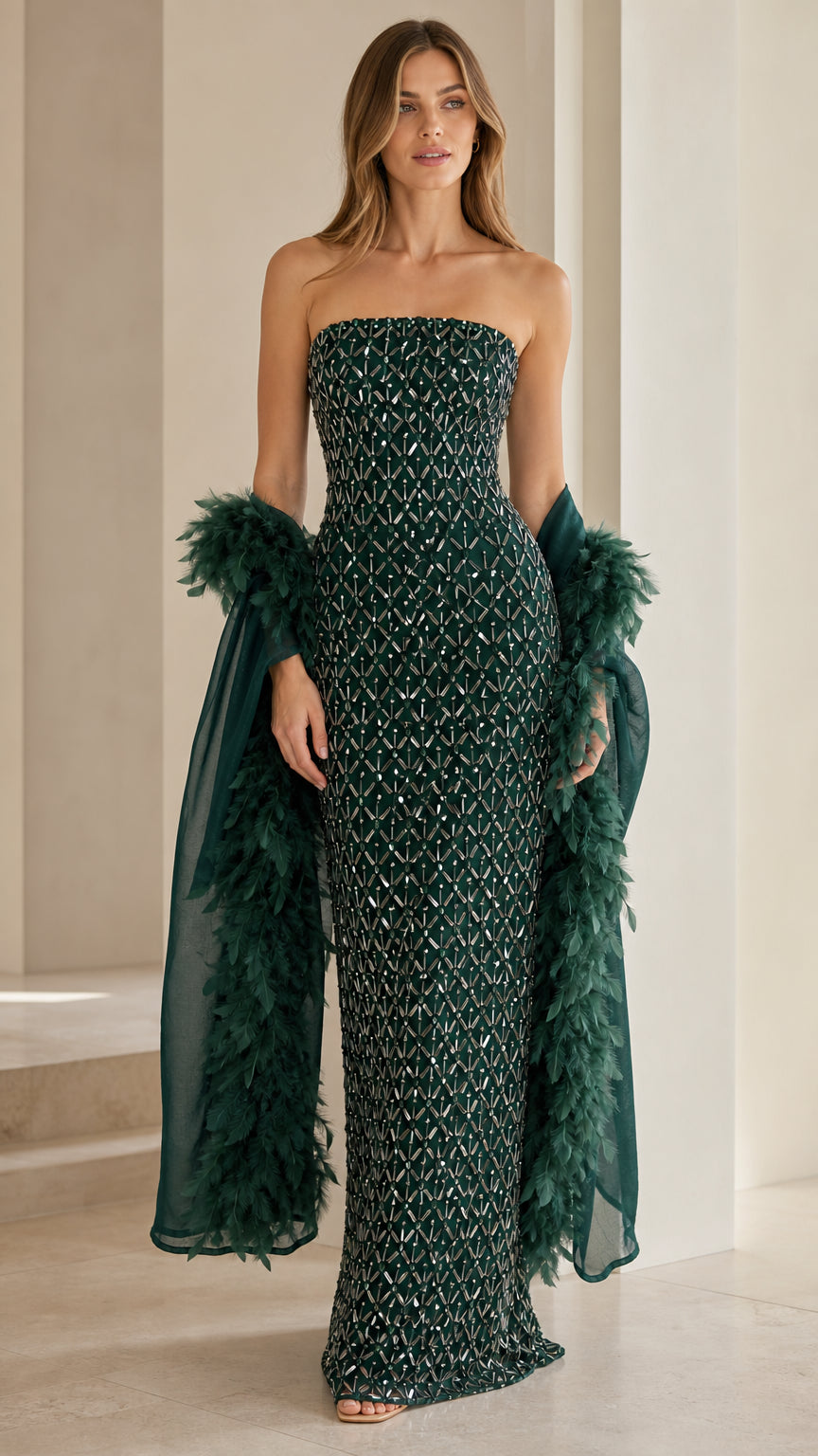 Front view of emerald green sequin strapless gown with feather wrap