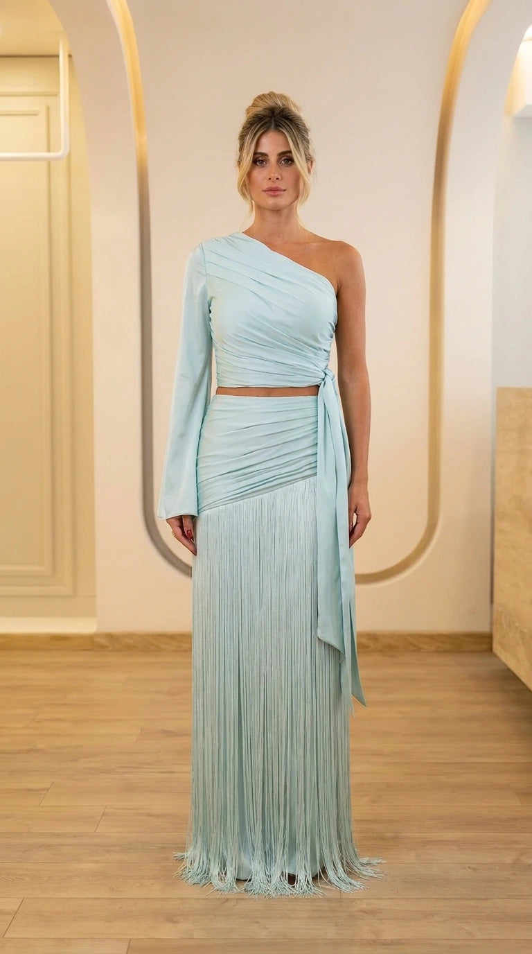 Front view of light blue one-shoulder crop top and fringe maxi skirt set