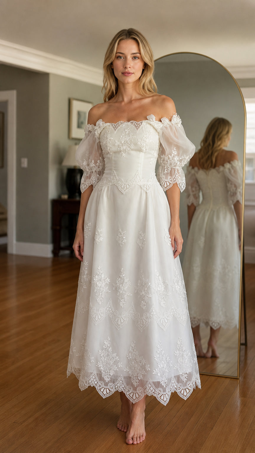 Front view of woman wearing white off-shoulder embroidered midi dress