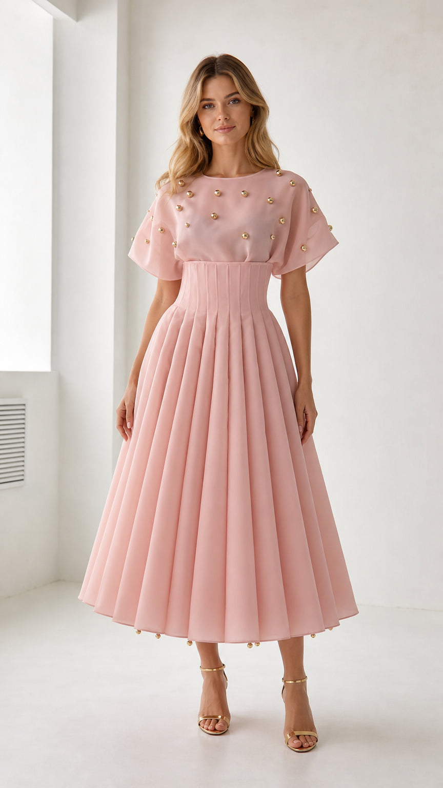 Front view of model wearing pink pearl embellished pleated midi dress