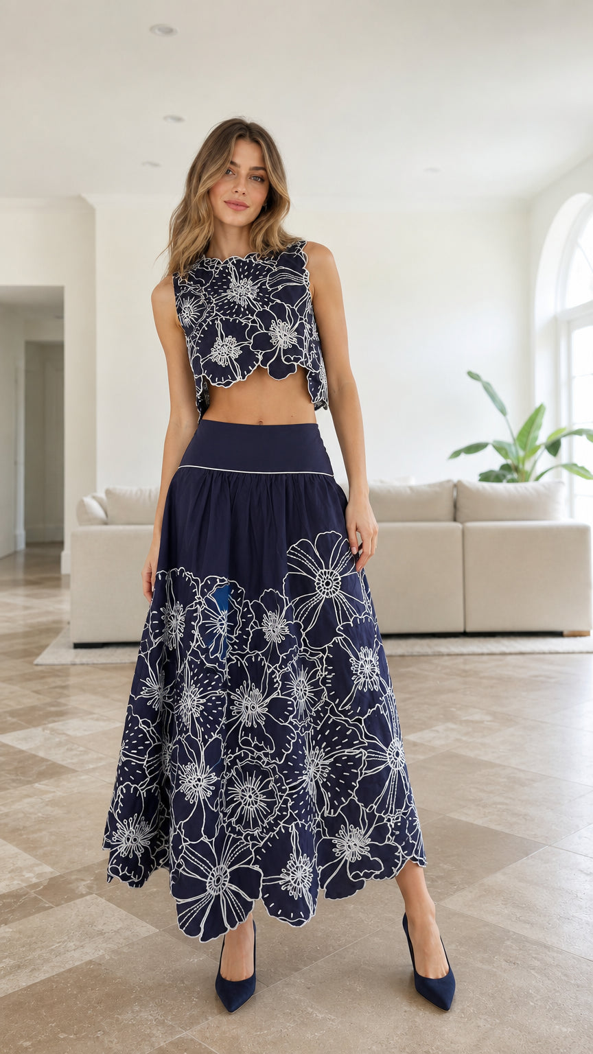 Model wearing navy embroidered floral crop top and maxi skirt set