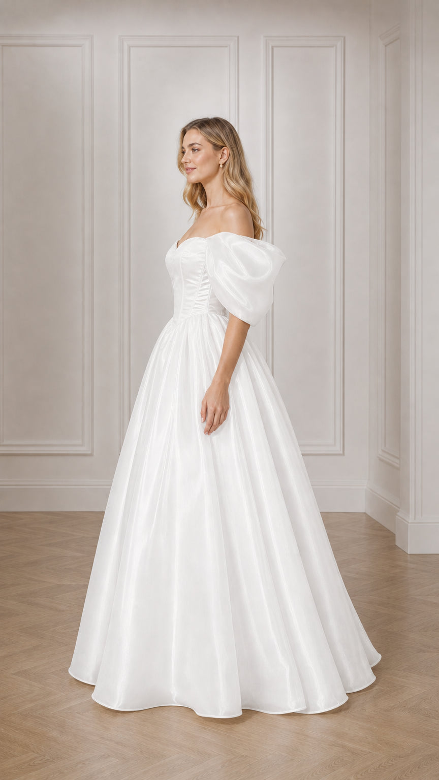Side profile of woman in white satin ball gown