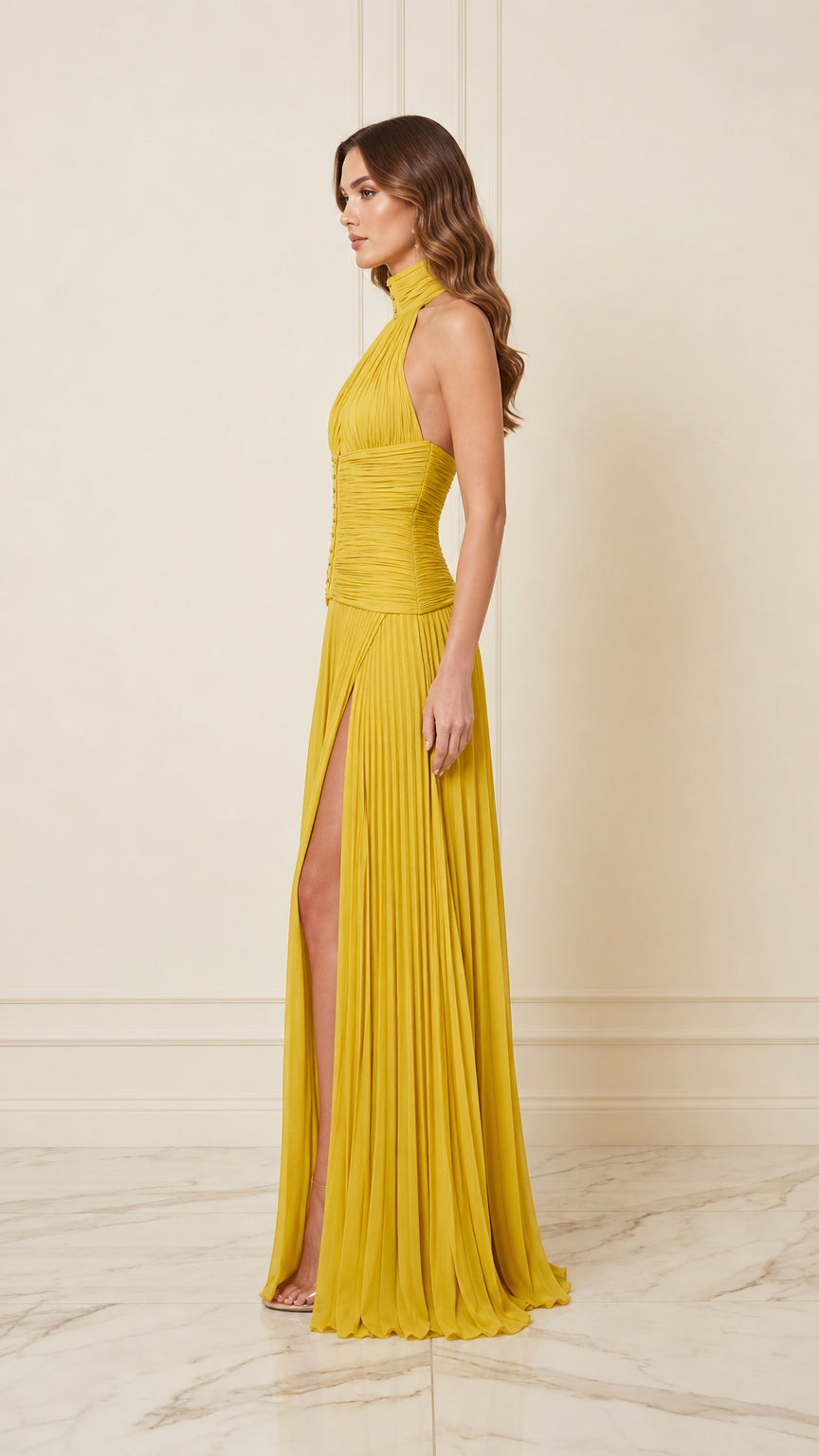 Side view of yellow pleated halter evening dress