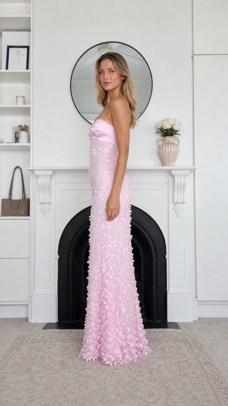 Side profile view of pink strapless maxi dress