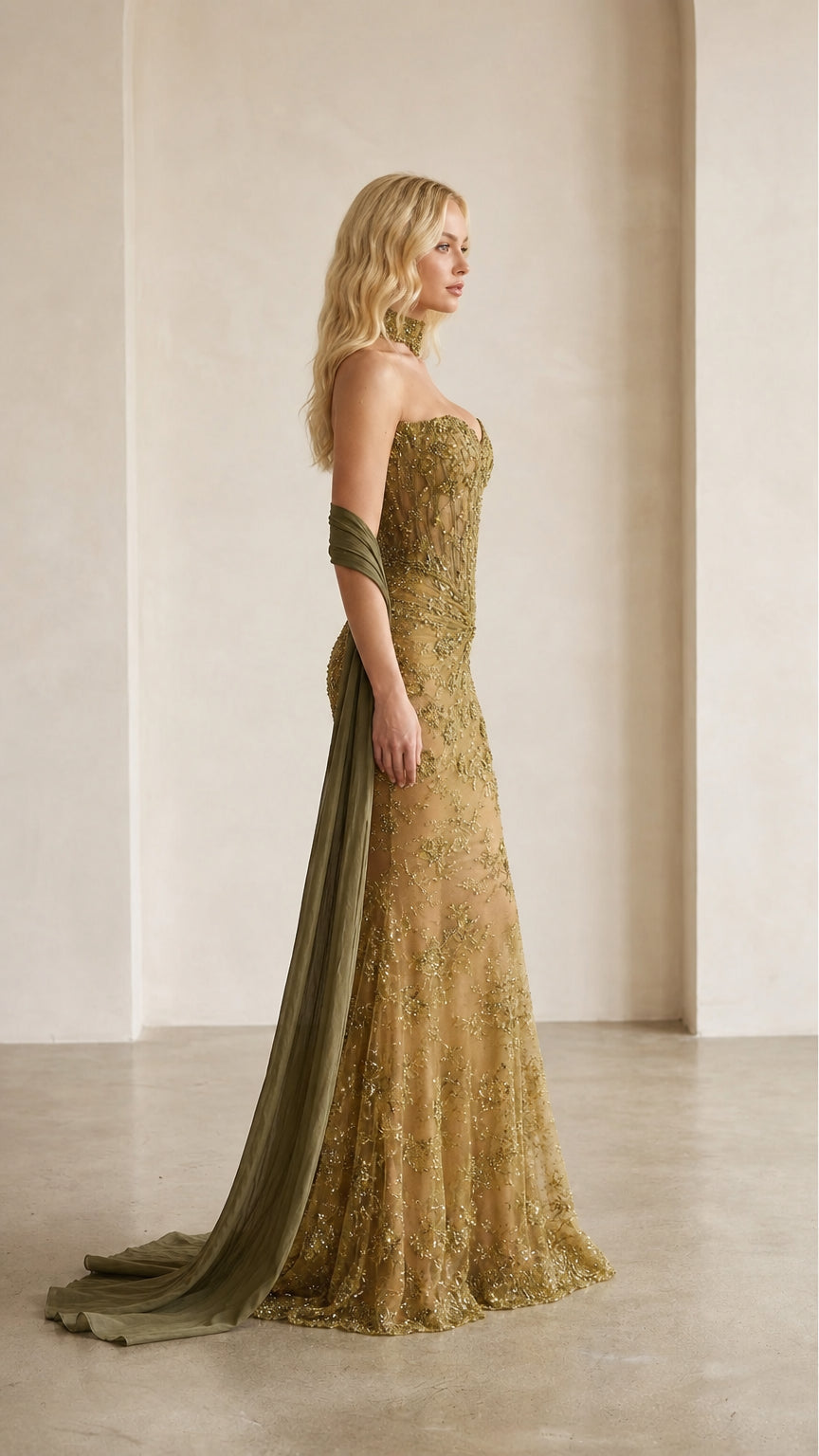 Side profile view of gold evening gown showcasing mermaid silhouette