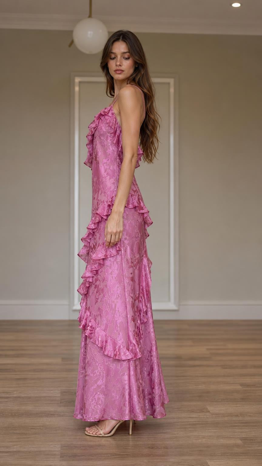 Side profile view of pink ruffled maxi dress