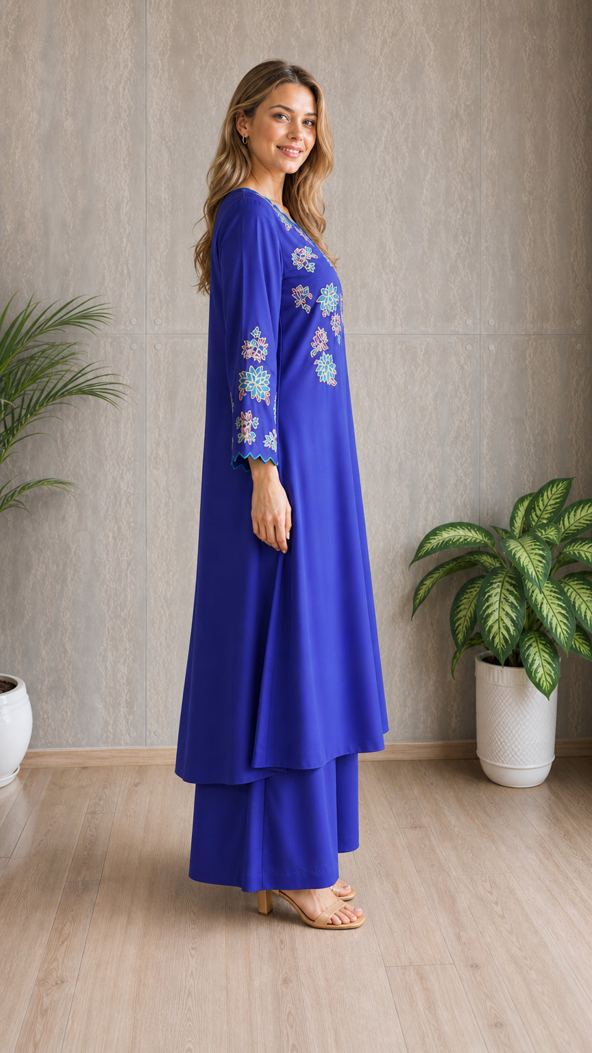 Model wearing royal blue embroidered tunic set, side view