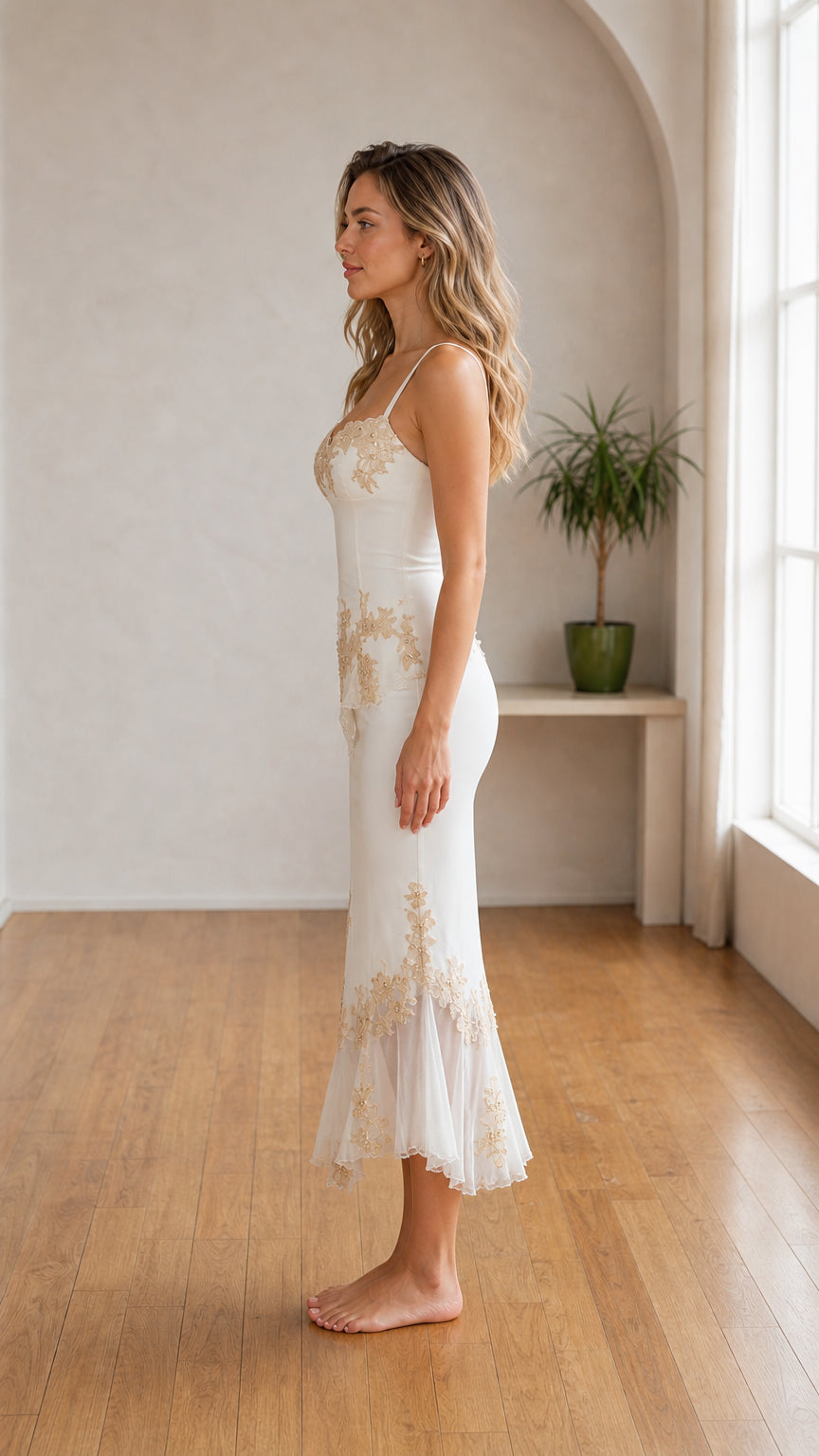 Side profile view of White embroidered slip midi dress