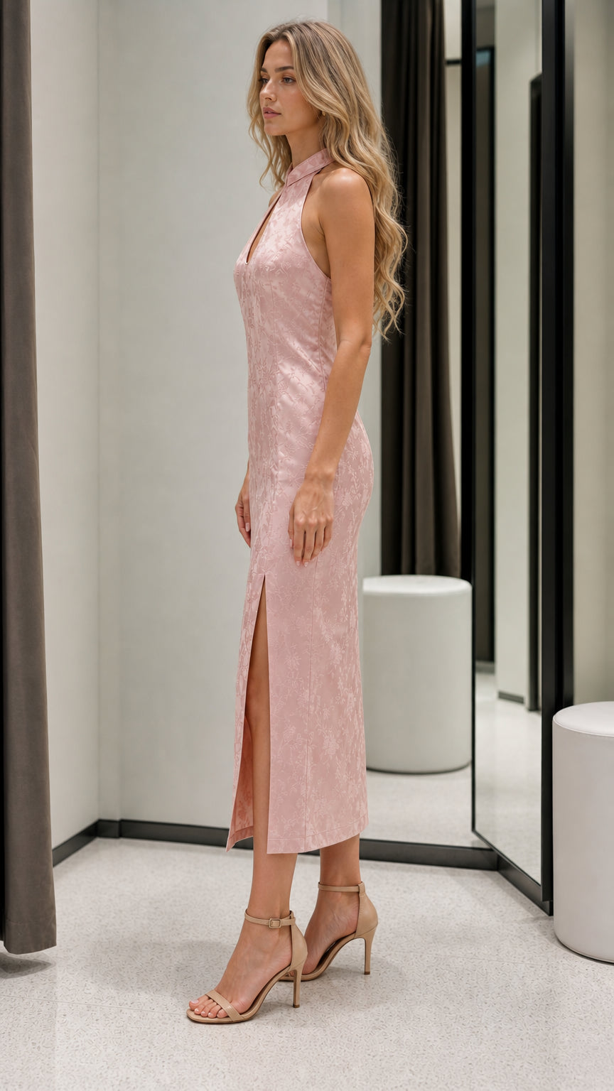 Side profile view of pink midi dress with high slit