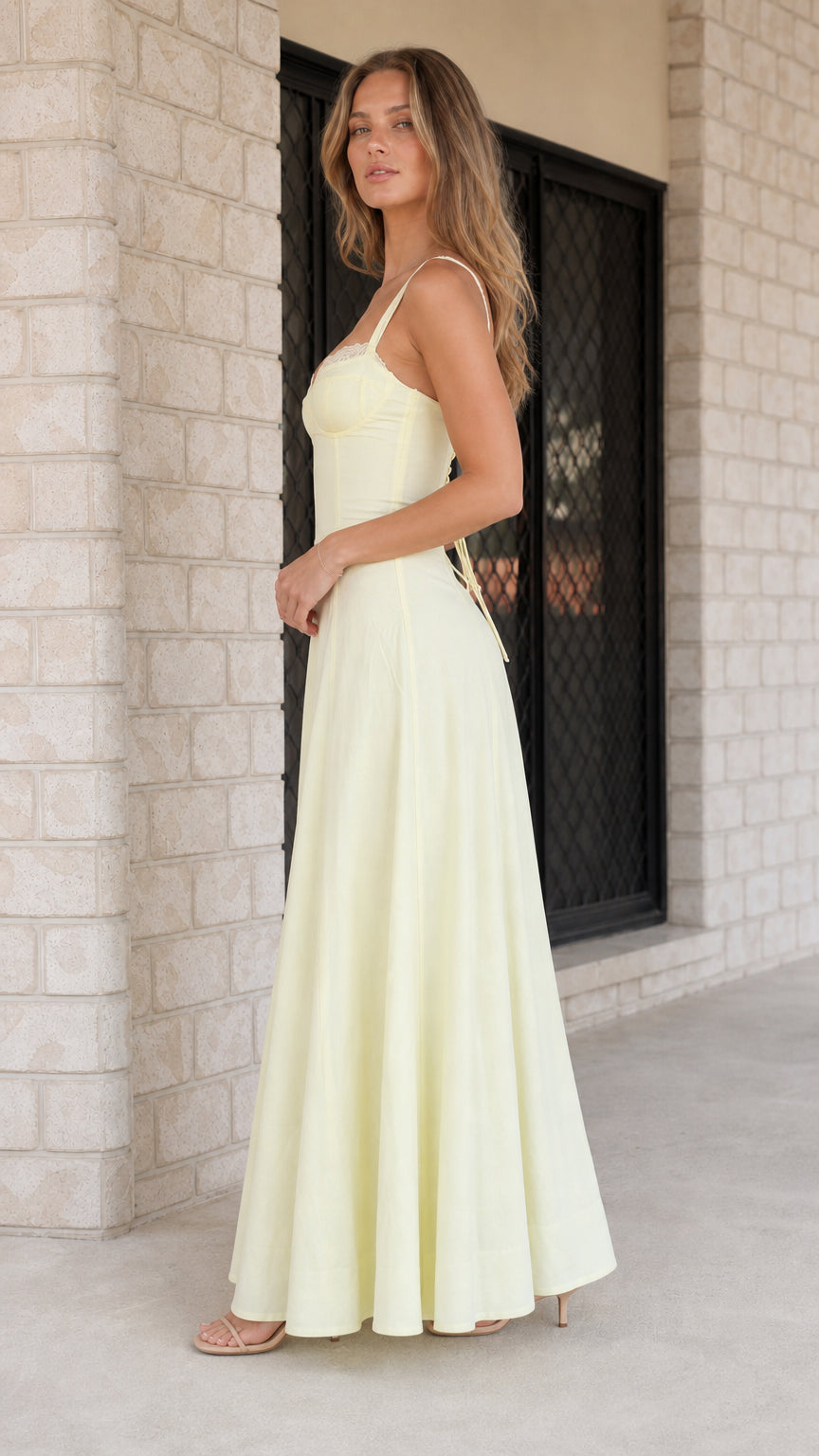 Side profile of woman wearing yellow maxi dress