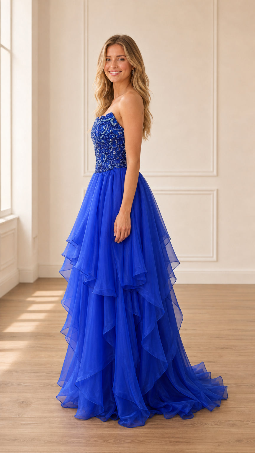 Side profile view of royal blue tiered tulle gown