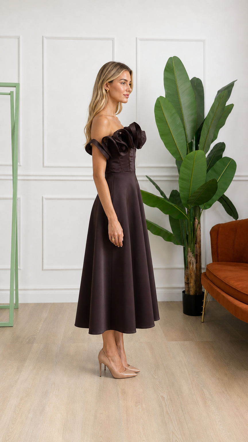 Side profile view of woman wearing brown midi dress