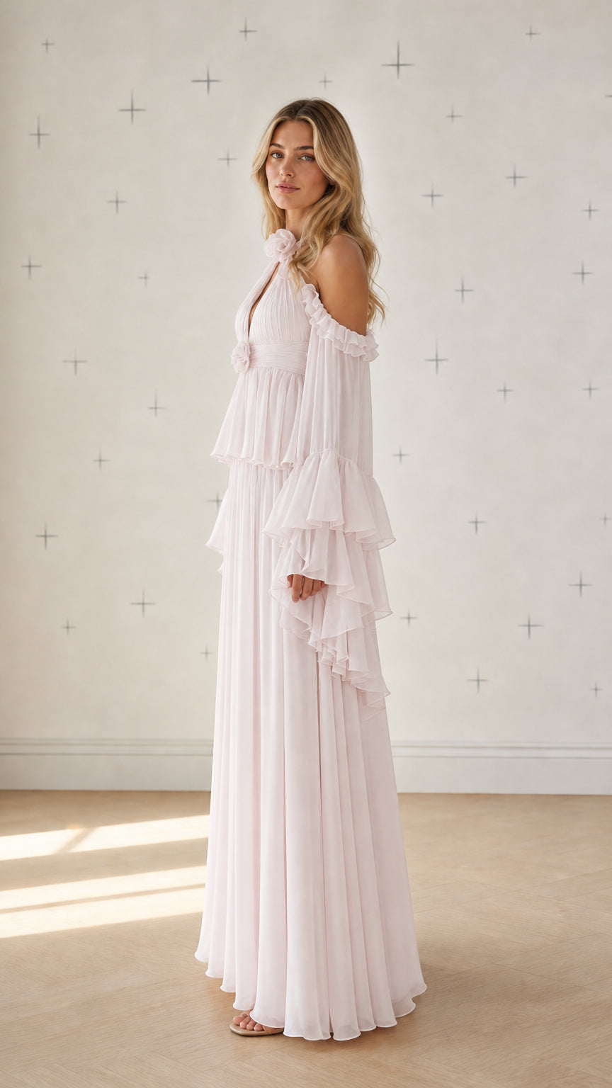 Side profile view of pink pleated maxi dress with ruffle sleeves