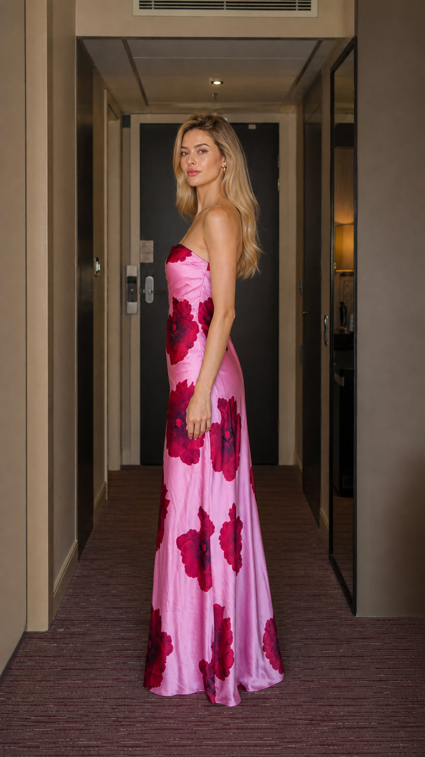 Side profile of model wearing pink floral satin maxi dress