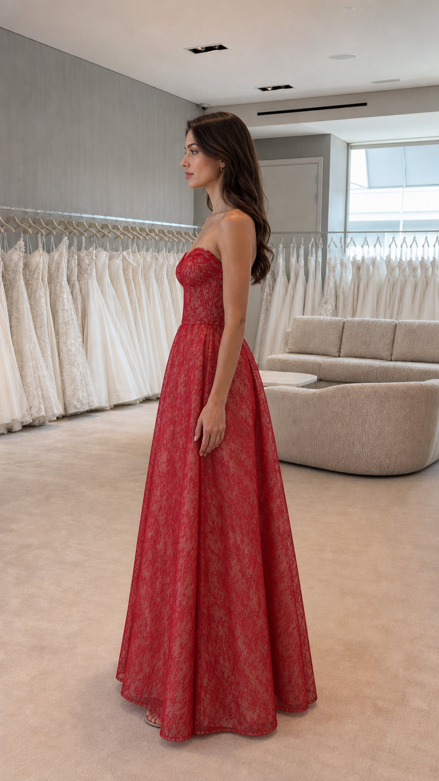 Side profile view of red strapless lace evening gown