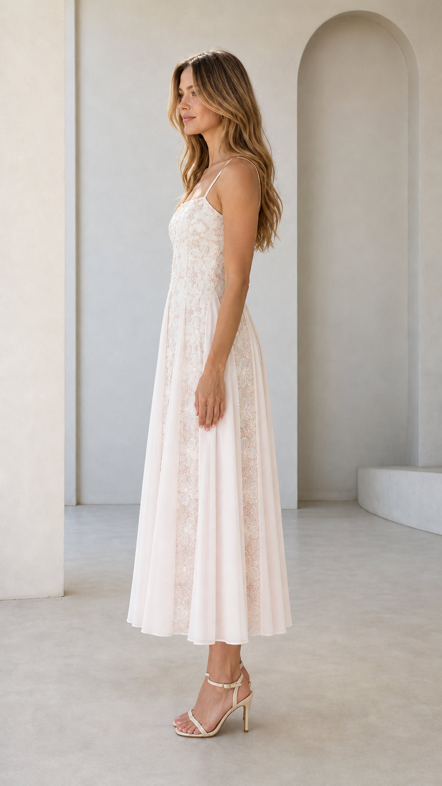 Side profile view of pink embroidered midi dress