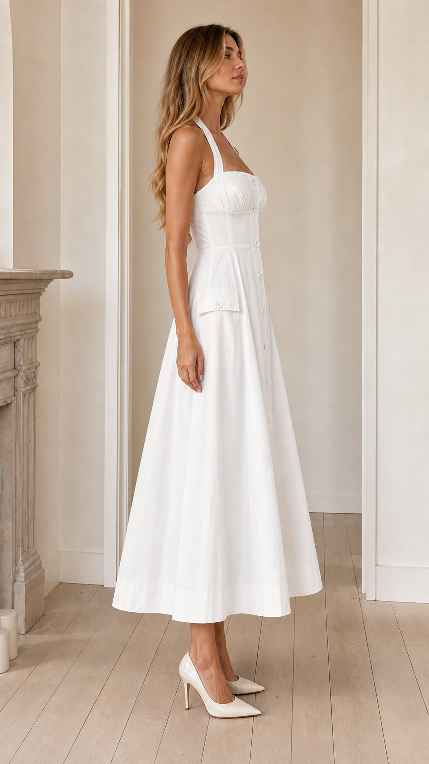 Side profile view of white halter midi dress