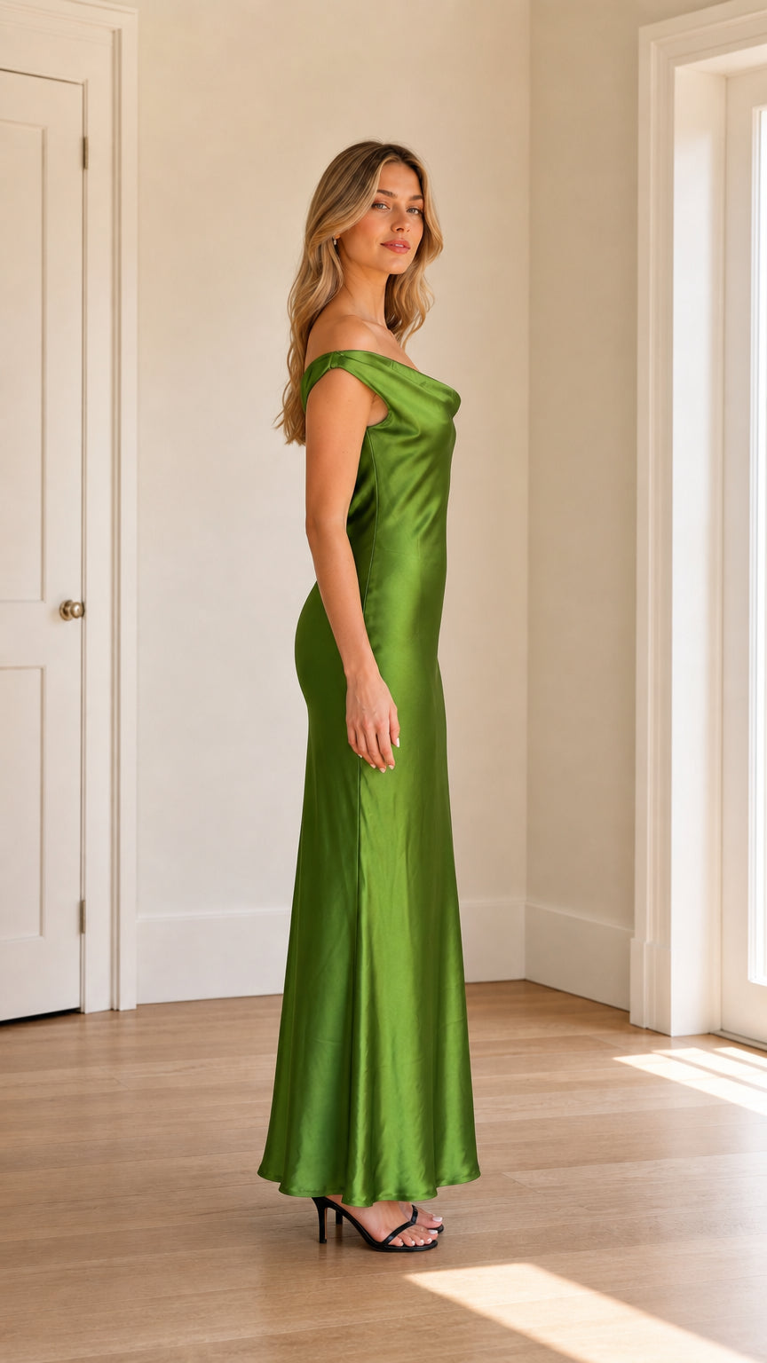 Side profile of model in green satin maxi dress