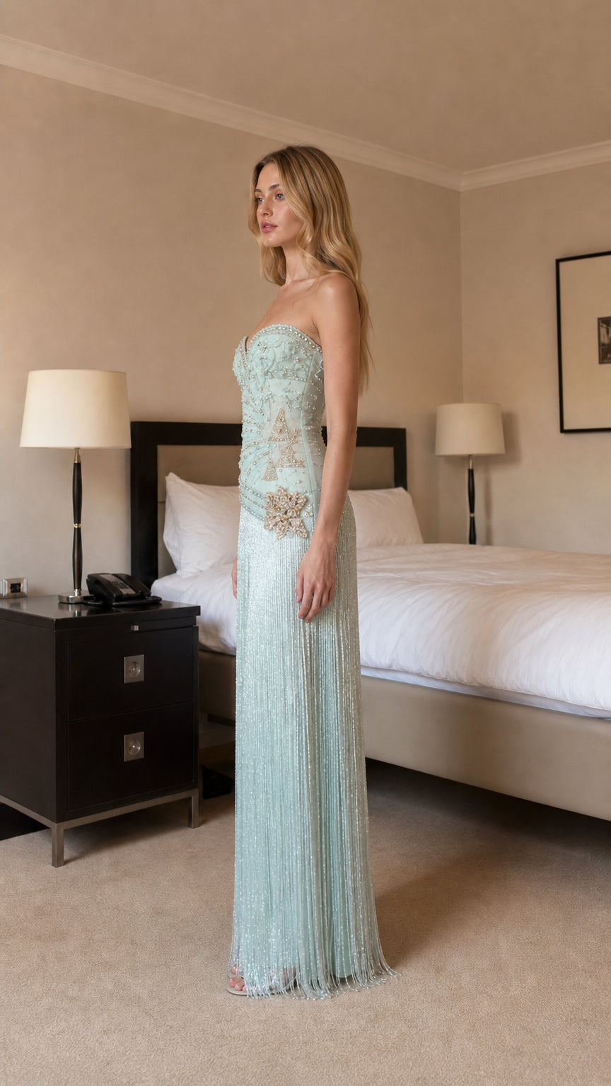 Side profile view of mint beaded evening dress
