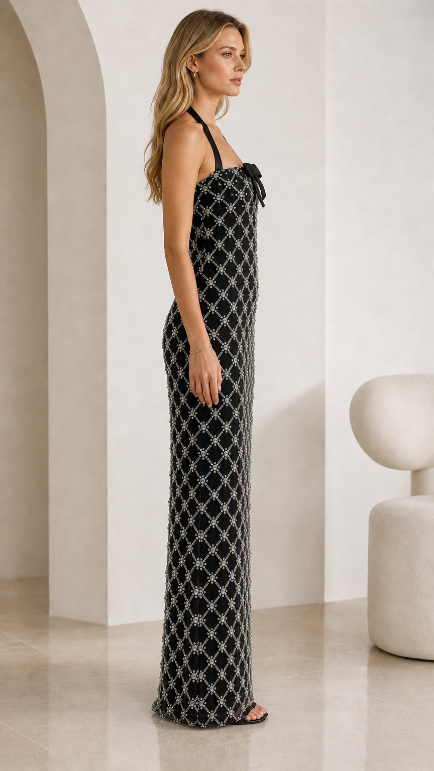Side profile view of black rhinestone halter maxi dress
