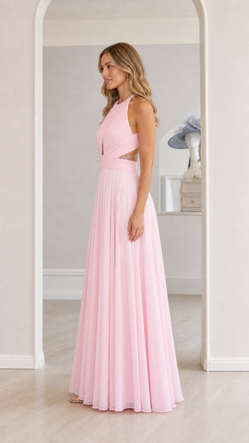 Model wearing pink chiffon halter maxi dress, side view