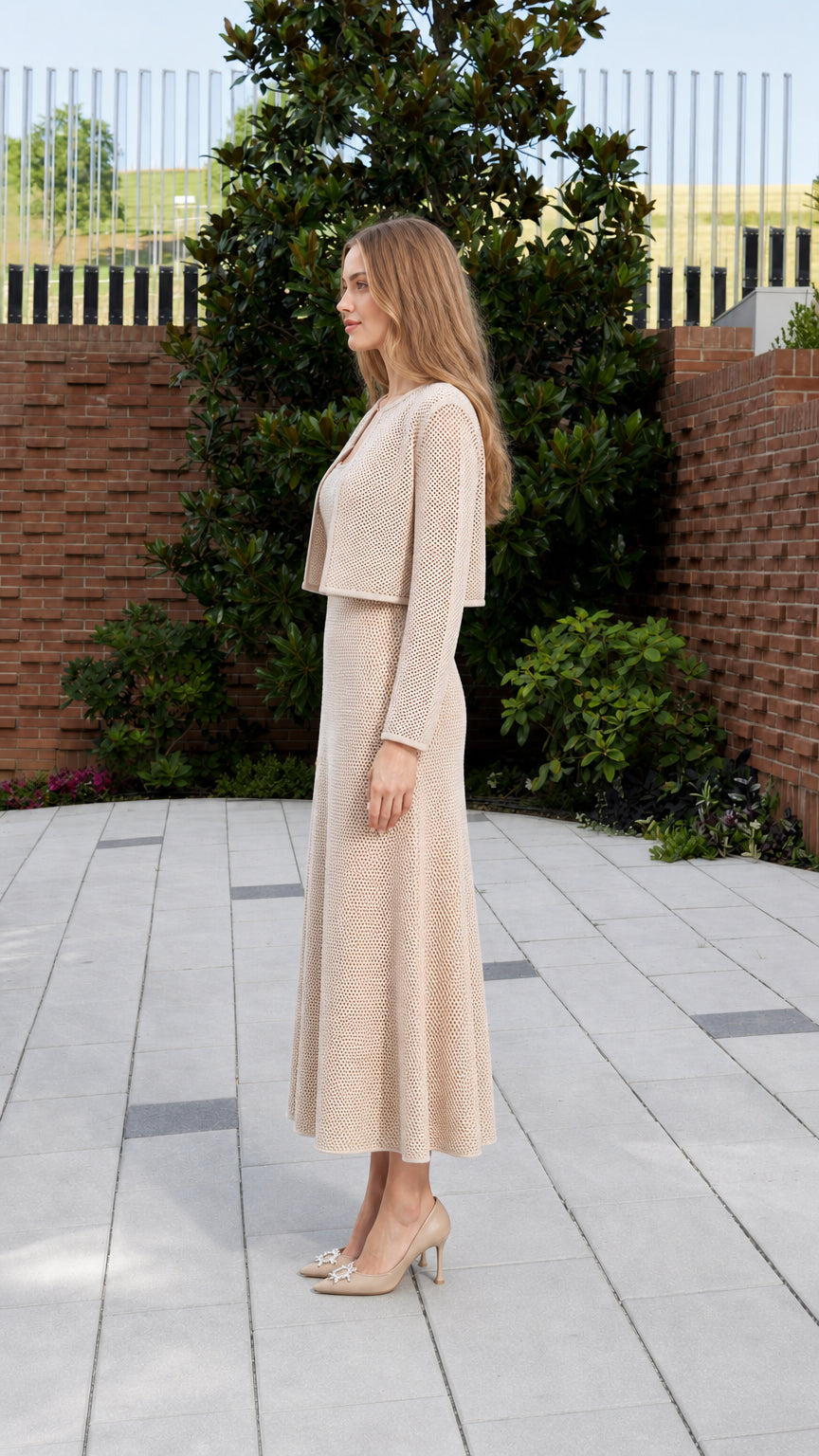 Side profile view of model in beige knit matching set