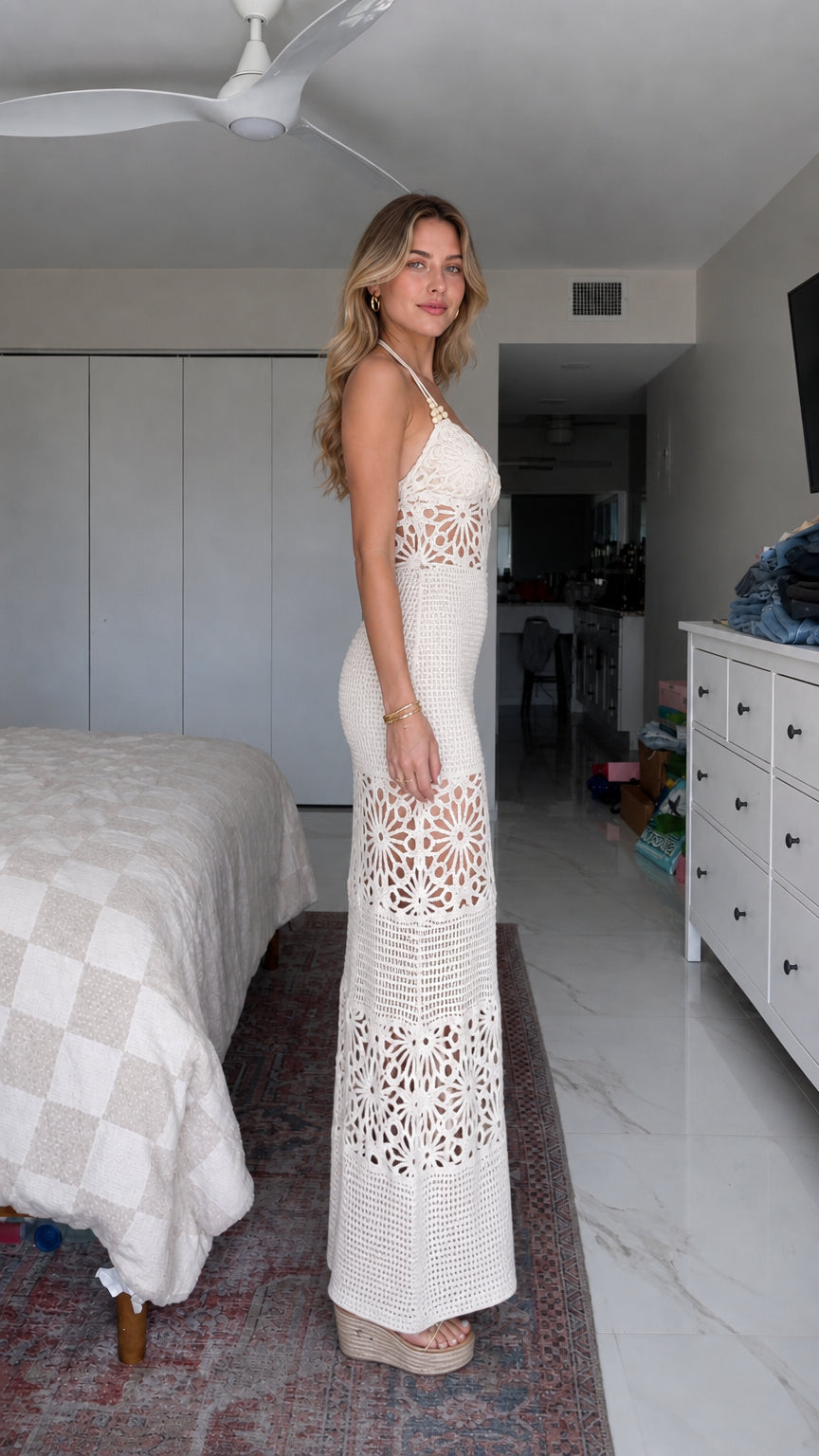 Side profile view of woman in white crochet maxi dress with wedge shoes