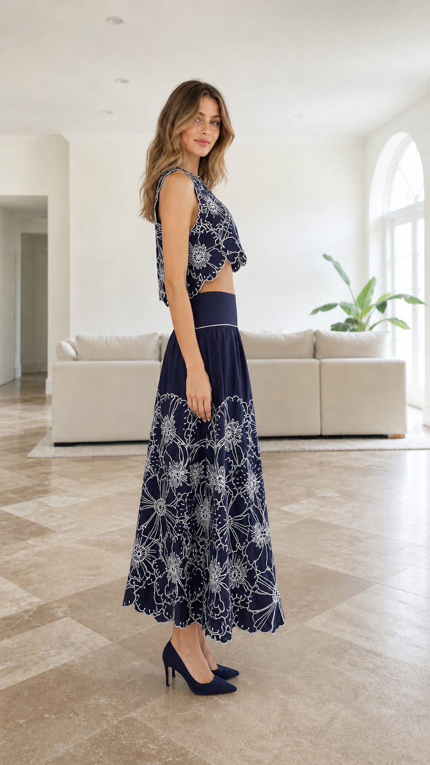 Side profile of model in navy embroidered two-piece set